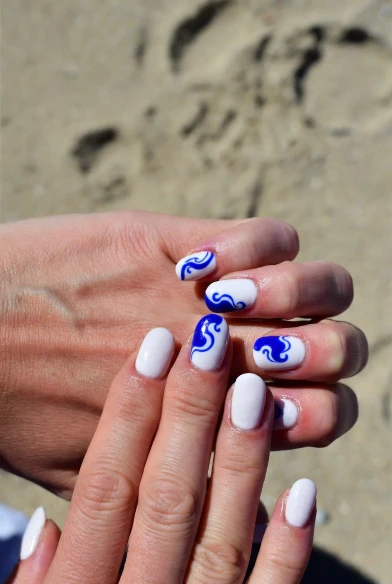 White Nails with Bold Blue Waves