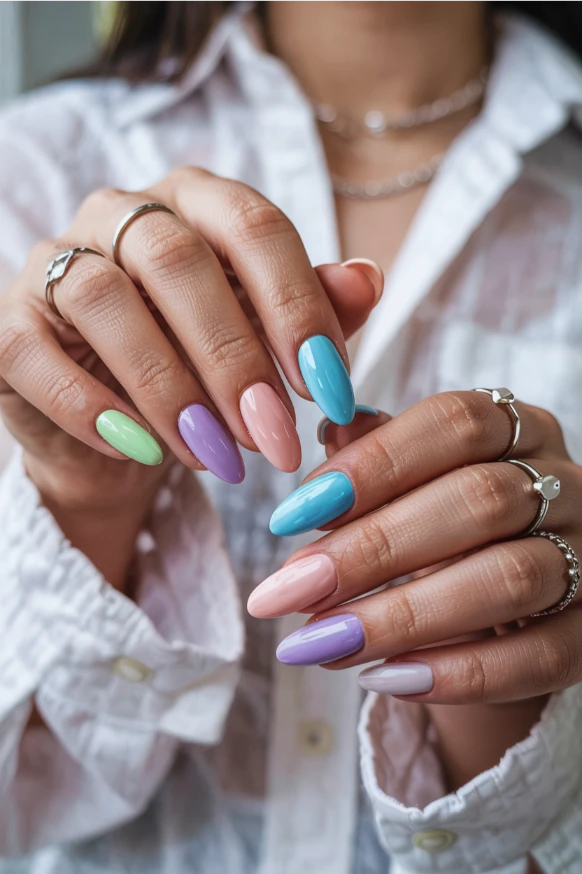 Pastel rainbow summer acrylic nails 2026 with soft almond shape and glossy pastel colors.