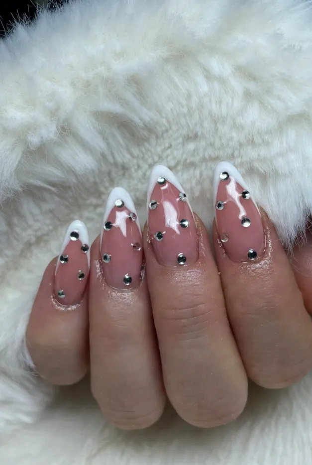 Rhinestone French tip nails with glossy pink base and silver crystal accents for glam summer nails 2026.