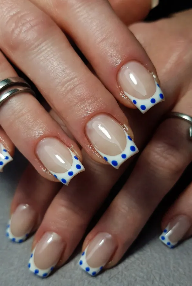 Blue polka dot French tip nails on square coffin nails for a fresh summer French manicure idea.