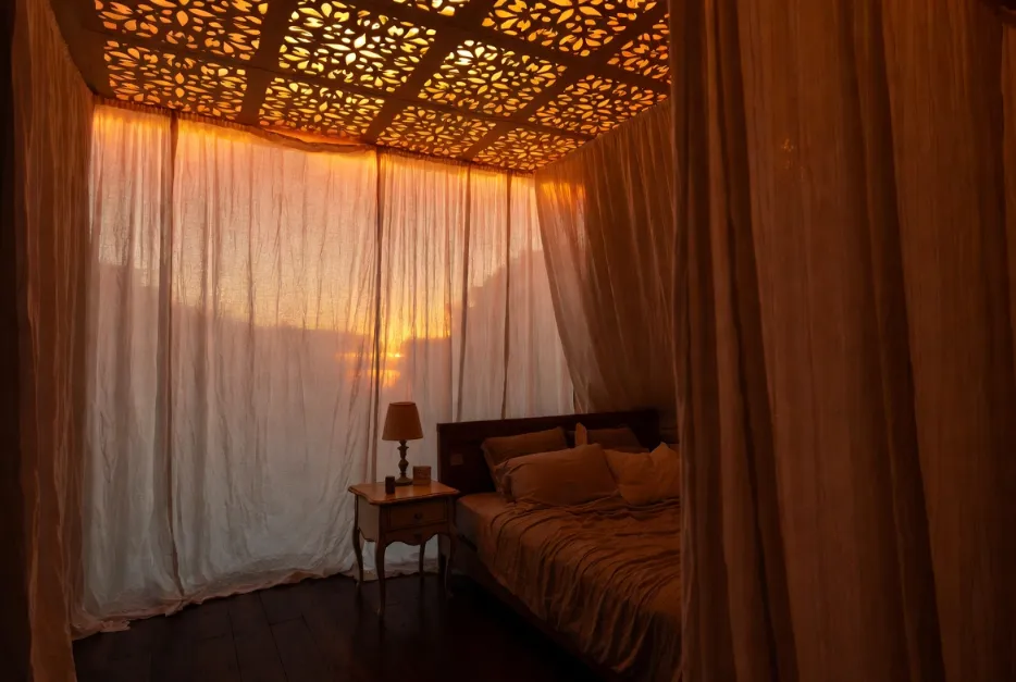 Floral cutout backlit false ceiling design in a romantic bedroom with warm patterned lighting.