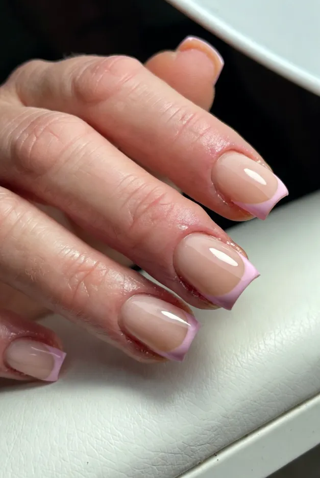 Baby pink square French tip nails with a glossy nude base for a simple summer manicure in 2026.