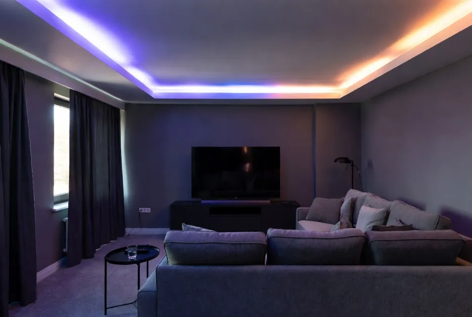 RGB mood lighting false ceiling design in a modern media room with colorful LED layers.