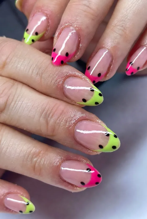 Watermelon French tip nails with lime green tips and tiny seed details for a playful summer manicure.