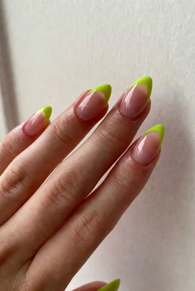 Neon lime French tip nails on a sheer pink base for a bold summer French tip nails 2026 look.