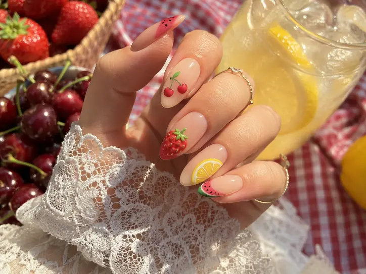 Fruit-inspired June nails with cherries, strawberries, lemon art, and watermelon tips.