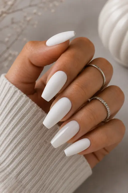 Matte white coffin nails with a soft modern finish and subtle glossy accent.